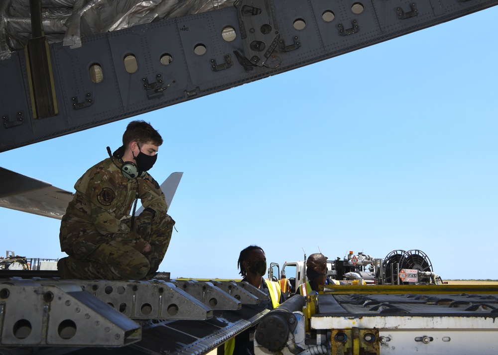 Senior Airman Tyler Ashworth off-loads a mobile field hospital from a C-17