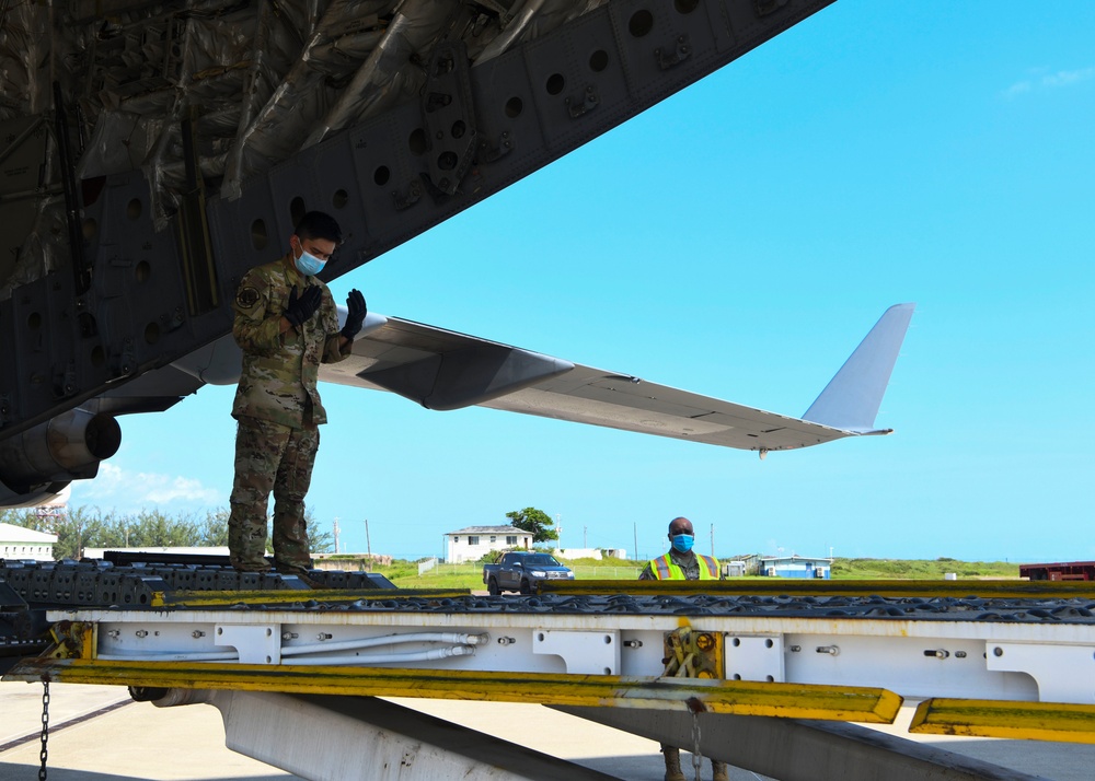 A1C Virgilio Frial off-loads a mobile field hospital from a C-17