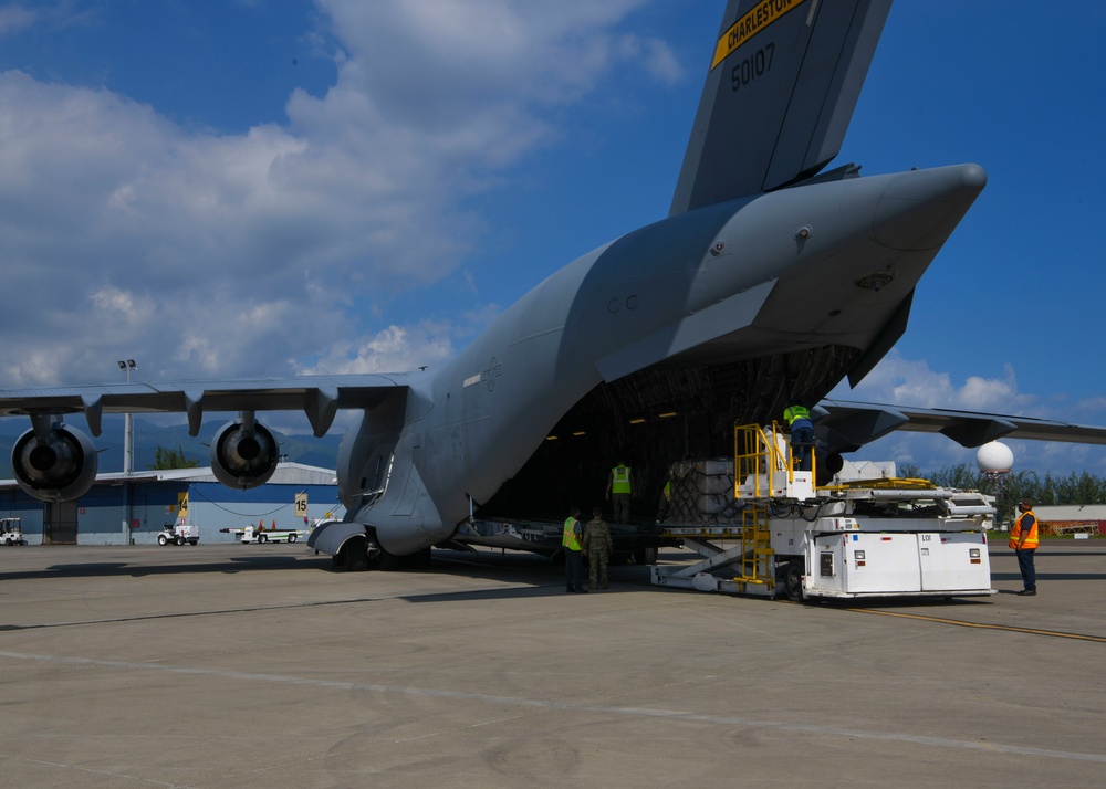 Loadmasters off-load a mobile field hospital from a C-17