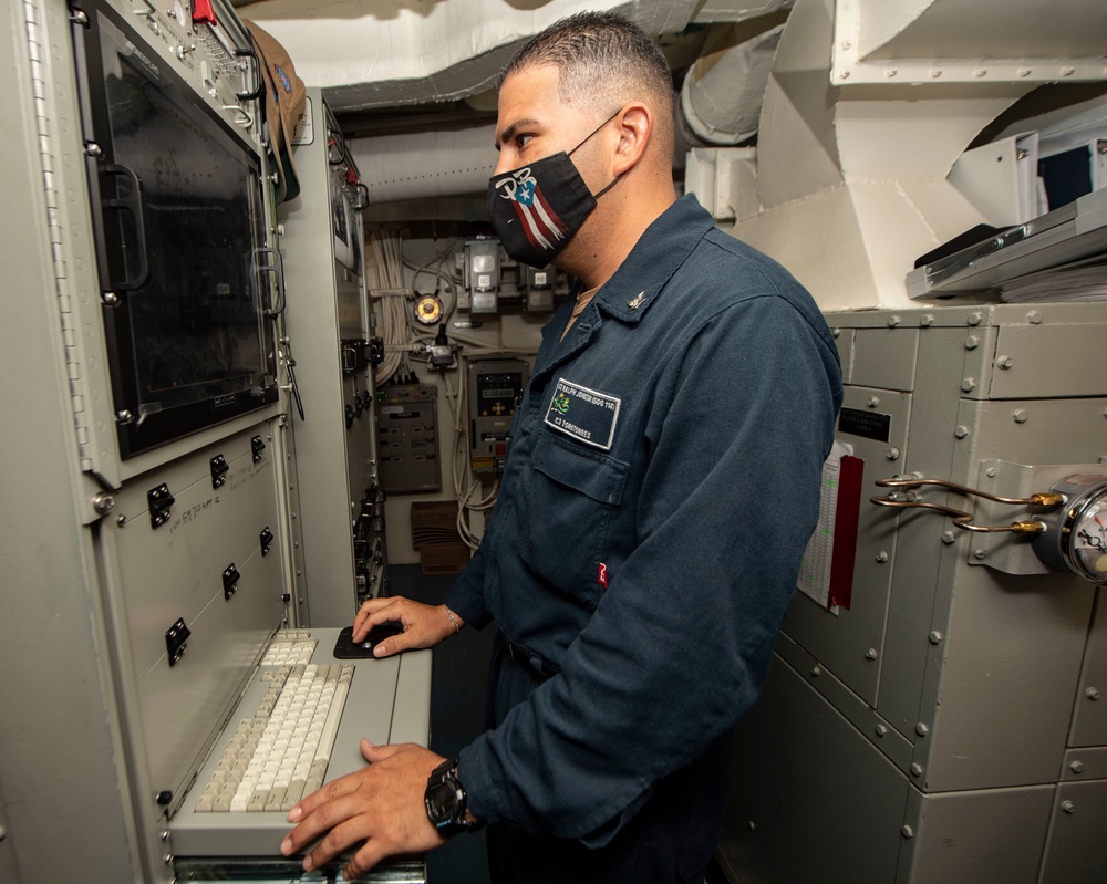 Sailor Conducts Maintenance on a Data Router