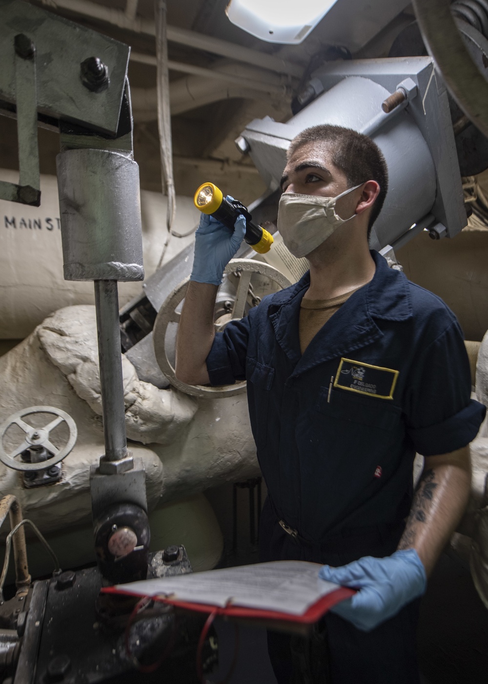 Sailor Performs Maintenance On Steam Outlet