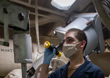 Sailor Performs Maintenance On Steam Outlet
