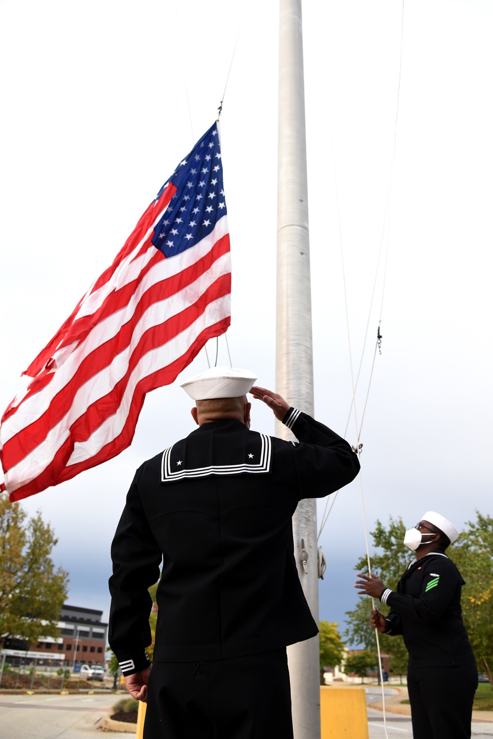 Sailors hoist the National Ensign during morning colors on NSA Philadelphia.