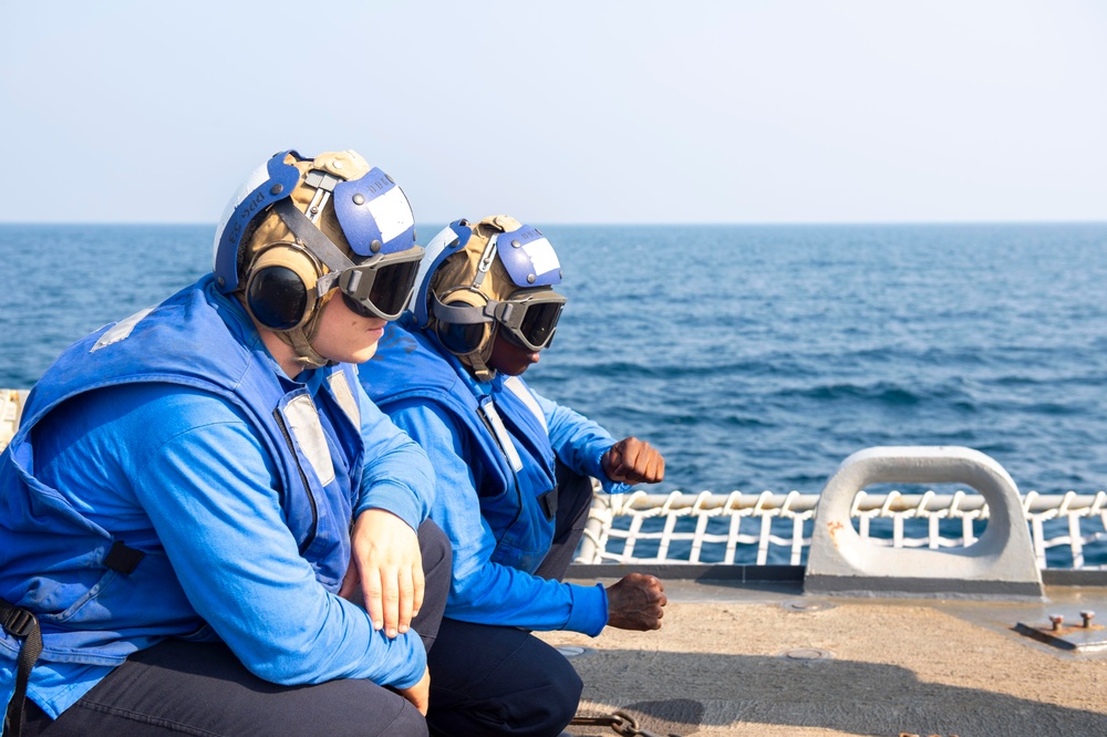 John Paul Jones Sailors prepare to chock and chain helicopter