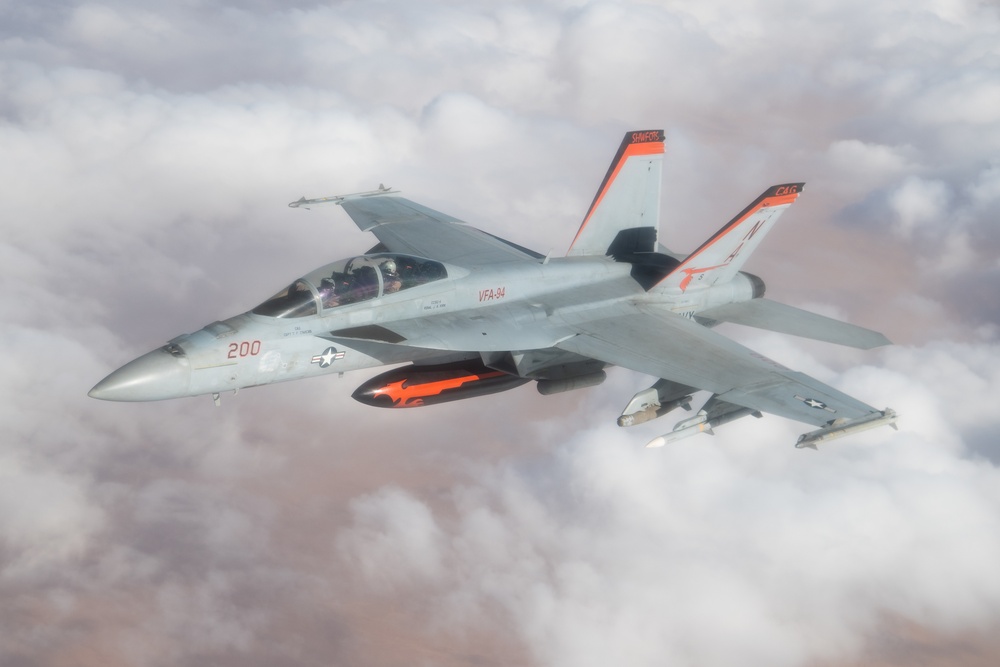 A U.S. Air Force KC-135 Stratotanker refuels a Navy F/A-18 Super Hornet