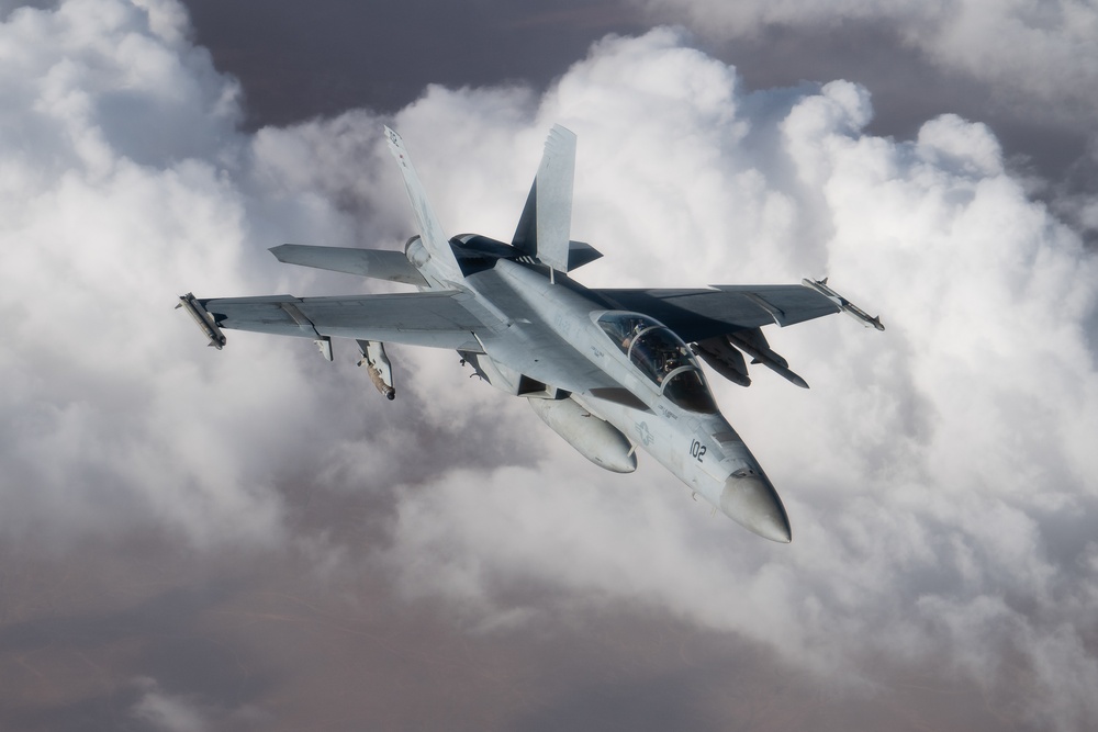 A U.S. Air Force KC-135 Stratotanker refuels a Navy F/A-18 Super Hornet