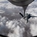 A U.S. Air Force KC-135 Stratotanker refuels Navy F/A-18 Super Hornets