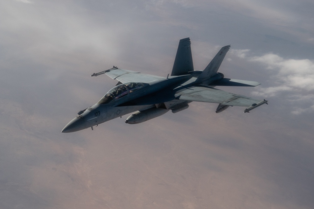 A U.S. Air Force KC-135 Stratotanker refuels a Navy F/A-18 Super Hornet