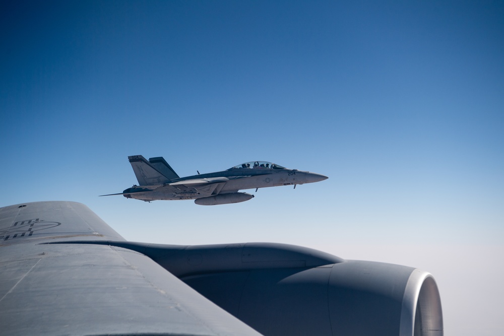 A U.S. Air Force KC-135 Stratotanker refuels a Navy F/A-18 Super Hornet