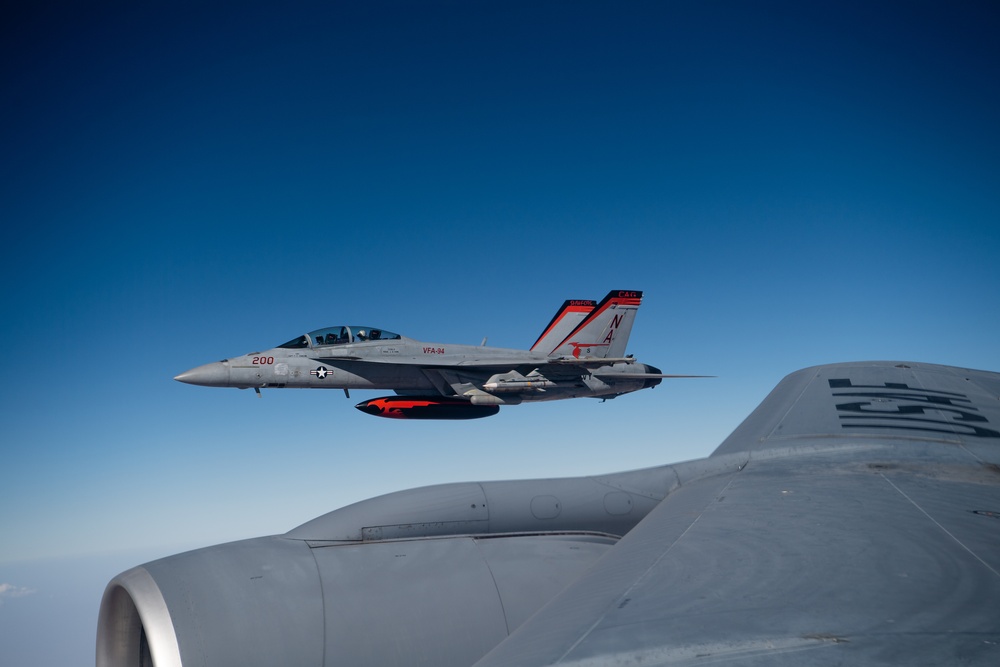 A U.S. Air Force KC-135 Stratotanker refuels a Navy F/A-18 Super Hornet