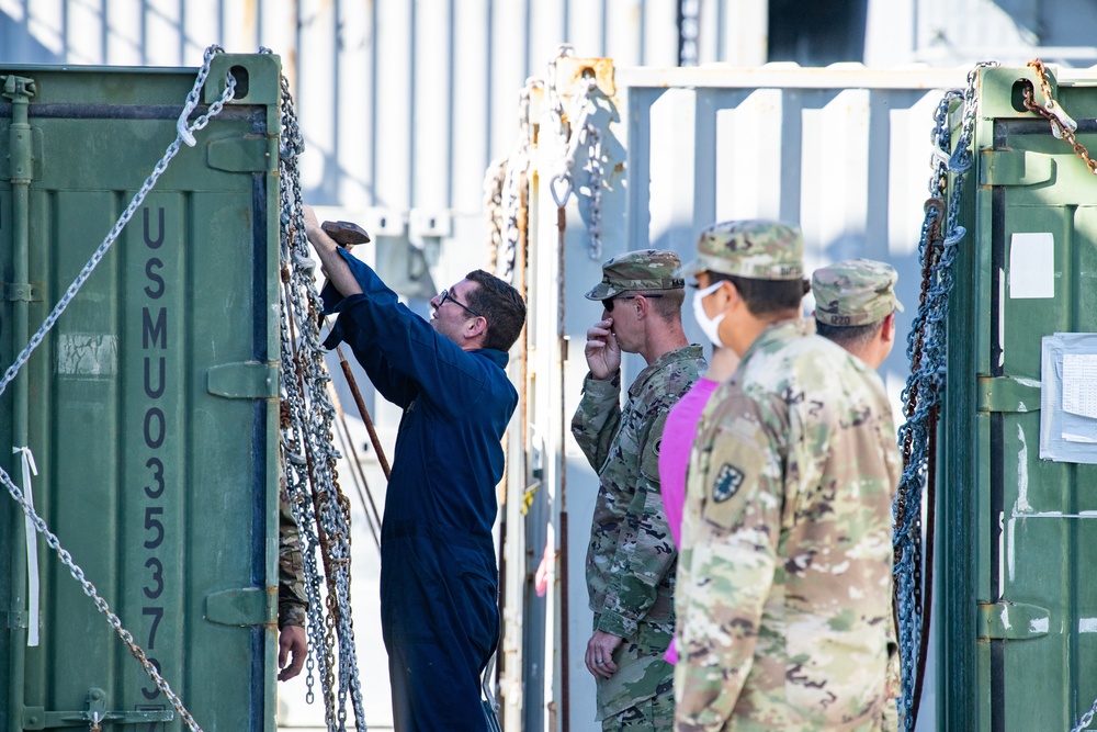 Crew Members Unload Equipment From LSV 5