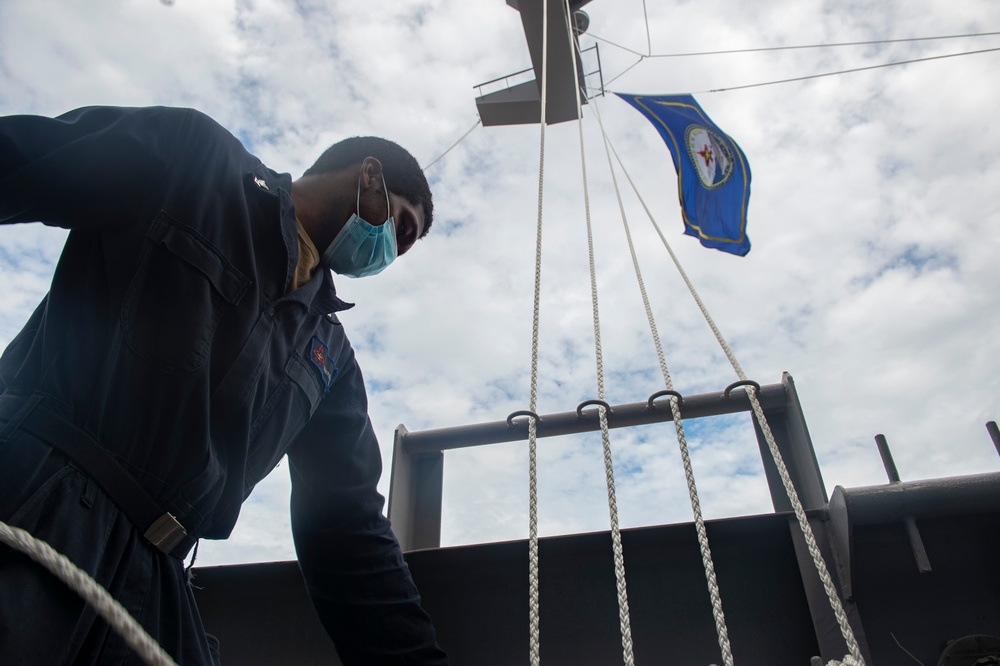 GHWB Sailor Secures Flag