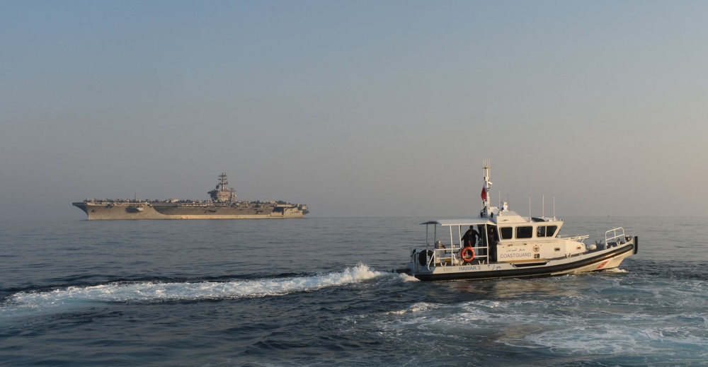 Bahrain Coast Guard escorts the USS Nimitz through the Gulf of Bahrain for maintenance and logistics visit