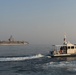 Bahrain Coast Guard escorts the USS Nimitz through the Gulf of Bahrain for maintenance and logistics visit