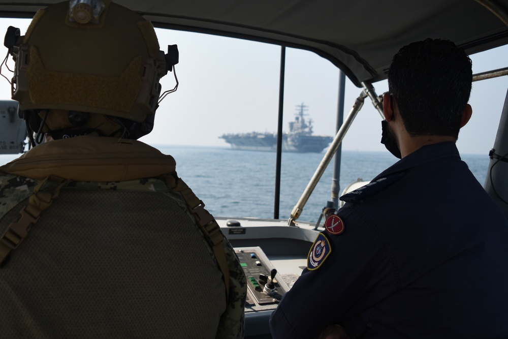 Bahrain Coast Guard escorts the USS Nimitz through the Gulf of Bahrain for maintenance and logistics visit