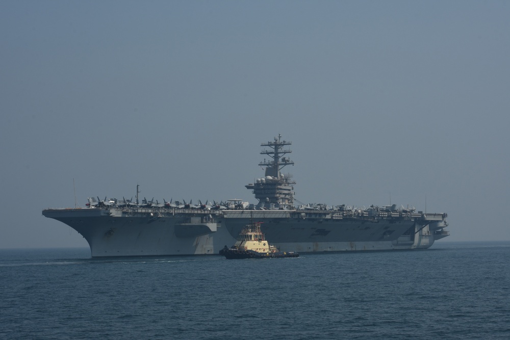 Bahrain Coast Guard escorts the USS Nimitz through the Gulf of Bahrain for maintenance and logistics visit