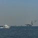 Bahrain Coast Guard escorts the USS Nimitz through the Gulf of Bahrain for maintenance and logistics visit