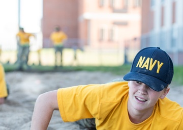 201014-N-TE695-0052 NEWPORT, R.I. (Oct. 14, 2020)  Navy Officer Candidate School (OCS) student low crawls at the obstacle course during battle stations