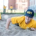 201014-N-TE695-0052 NEWPORT, R.I. (Oct. 14, 2020)  Navy Officer Candidate School (OCS) student low crawls at the obstacle course during battle stations