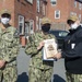 Logistics Specialist Seaman Patience Jones, middle, assigned to USS Constitution, is awarded Blue Jacket of the Quarter