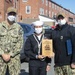 Boatswain’s Mate 2nd Class Jacklyn Ditzel, middle, assigned to USS Constitution, is awarded Sailor of the Quarter