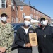 Naval Aircrewmen Helicopter 1st Class Charles Hardmon, middle, assigned to USS Constitution, is awarded Senior Sailor of the Quarter