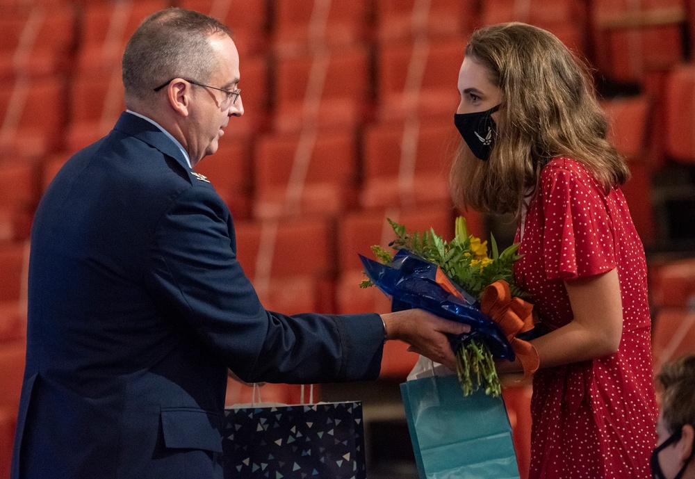 Air Force colonel presents flowers to daughter
