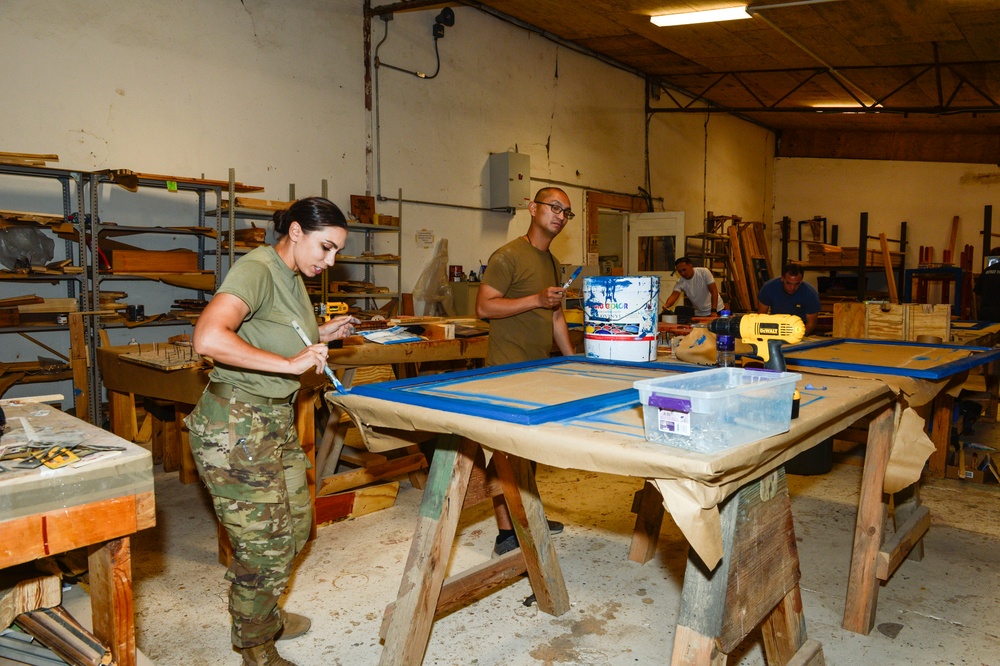 CAMP LEMONNIER SERVICE MEMBERS VOLUNTEER PAINTING FRAMES FOR GALLEY