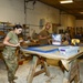 CAMP LEMONNIER SERVICE MEMBERS VOLUNTEER PAINTING FRAMES FOR GALLEY