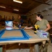 CAMP LEMONNIER SERVICE MEMBERS VOLUNTEER PAINTING FRAMES FOR GALLEY