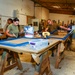 CAMP LEMONNIER SERVICE MEMBERS VOLUNTEER PAINTING FRAMES FOR GALLEY