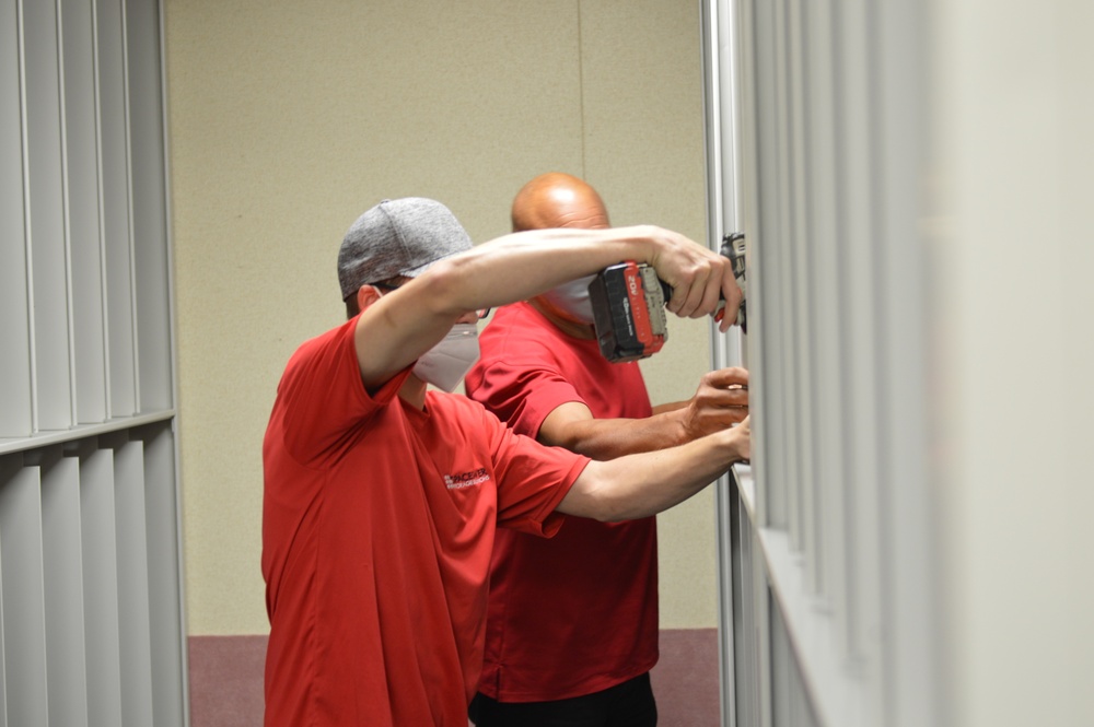 Contractors install metal shelving at Naval Museum Annex facility