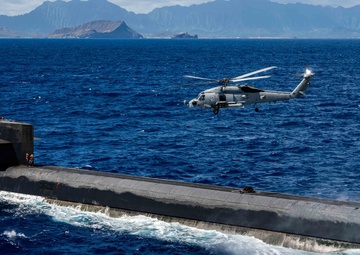 An MH-60R Sea Hawk Delivers a Payload to USS Henry M. Jackson