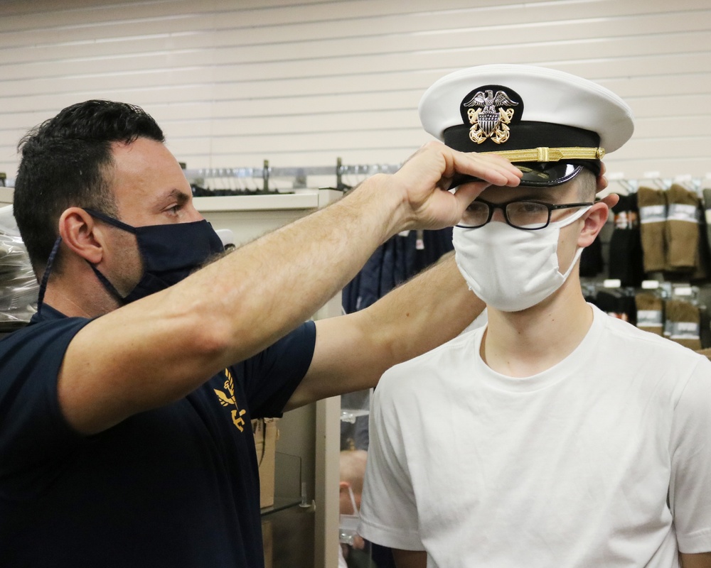 201017-N-KV911-0018 NEWPORT, R.I. (Oct. 17, 2020)  Navy Officer Candidate School (OCS) student is fitted for a combination cover
