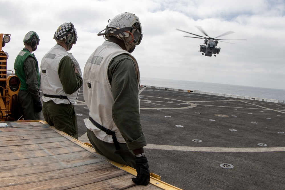 15th MEU Marines, USS San Diego Sailors unload helicopters while underway