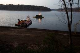 Floating barge with air curtain burner incinerates Lake Cumberland debris