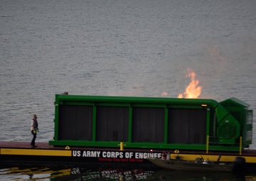 Floating barge with air curtain burner incinerates Lake Cumberland debris