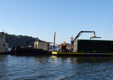 Floating barge with air curtain burner incinerates Lake Cumberland debris
