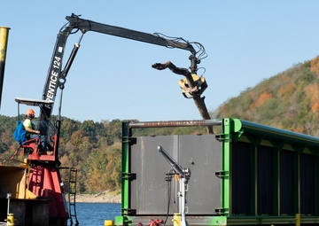 Floating barge with air curtain burner incinerates Lake Cumberland debris