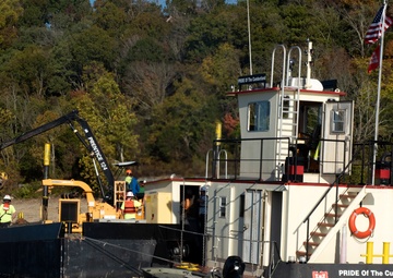 Floating barge with air curtain burner incinerates Lake Cumberland debris
