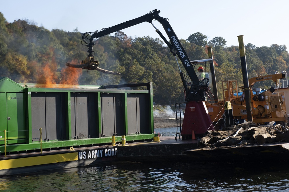 Floating barge with air curtain burner incinerates Lake Cumberland debris