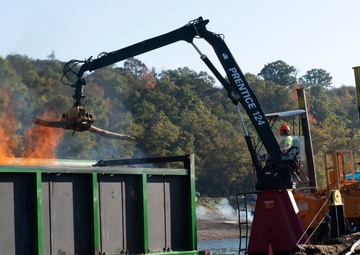 Floating barge with air curtain burner incinerates Lake Cumberland debris