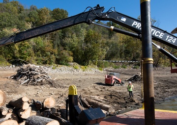 Floating barge with air curtain burner incinerates Lake Cumberland debris