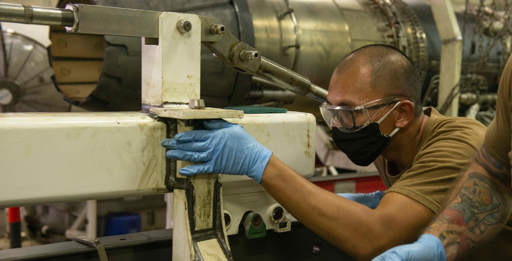 Sailor Performs Corrosion Treatment