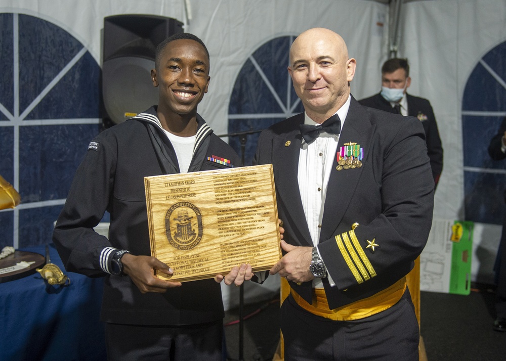 Logistics Specialist 3rd Class Jason Petitfrere (left) assigned to USS Constitution, is awarded the Lt. Kauffman Award by the 76th commanding officer of USS Constitution, Cmdr. John A. Benda (right).