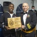 Logistics Specialist 3rd Class Jason Petitfrere (left) assigned to USS Constitution, is awarded the Lt. Kauffman Award by the 76th commanding officer of USS Constitution, Cmdr. John A. Benda (right).