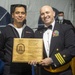 Seaman Alfonso OrtizLopez (left) assigned to USS Constitution, is awarded the Berenson Award by the 76th commanding officer of USS Constitution, Cmdr. John A. Benda (right)
