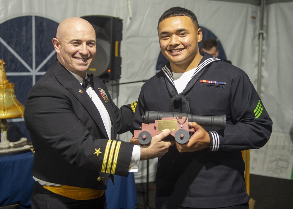 Airman Yummy Soaia (right) assigned to USS Constitution, is awarded Blue Jacket of the Year by the 76th commanding officer of USS Constitution, Cmdr. John A. Benda (left)