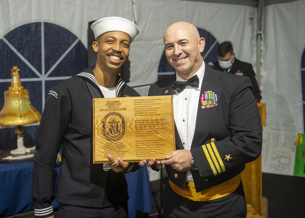 Naval Aircrewmen (Helicopter) 1st Class Charles Hardmon (left) assigned to USS Constitution, is awarded the Jans Valdespou Leadership Award by the 76th commanding officer of USS Constitution, Cmdr. John A. Benda (right)