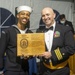 Naval Aircrewmen (Helicopter) 1st Class Charles Hardmon (left) assigned to USS Constitution, is awarded the Jans Valdespou Leadership Award by the 76th commanding officer of USS Constitution, Cmdr. John A. Benda (right)